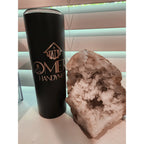 Black tumbler with 'Omet Handyman' branding next to a geode crystal on a light surface.
