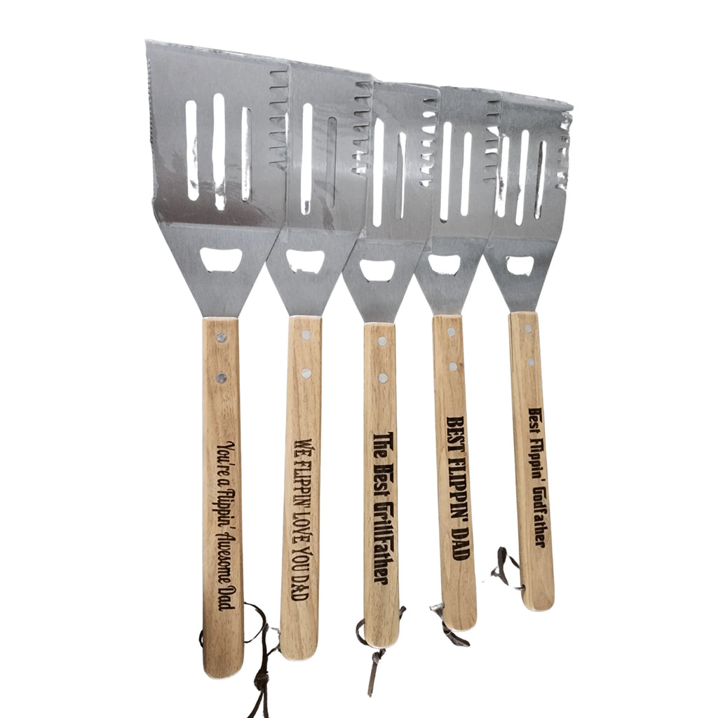 Set of four spatulas with wooden handles and engraved text on a white background