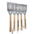 Set of four spatulas with wooden handles and engraved text on a white background