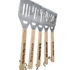 Set of four barbecue utensils with wooden handles and engraved text on a white background