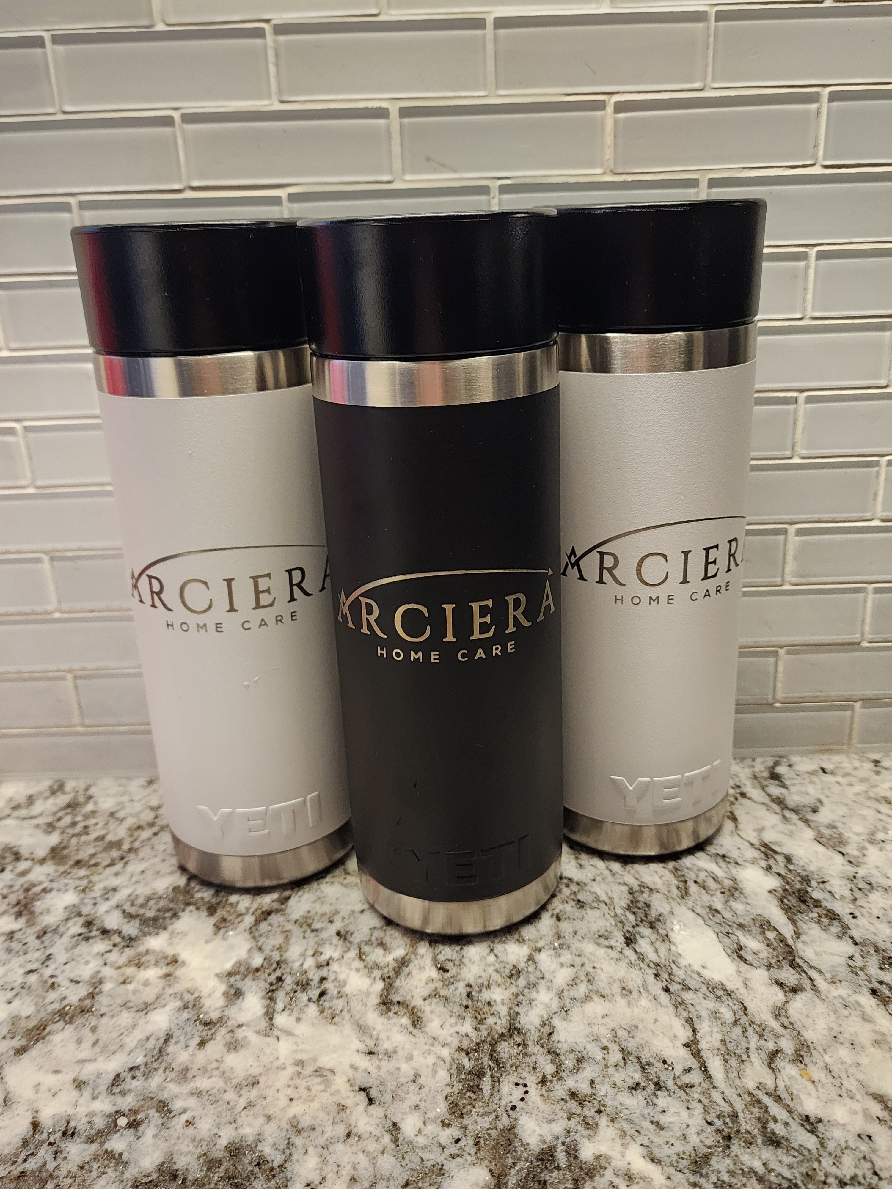 Three  with black, silver, and white design on a marble surface.