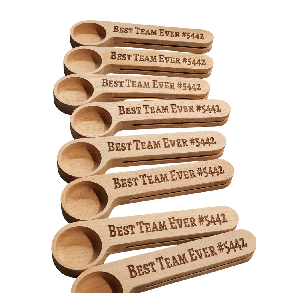 Set of wooden spoons with 'Best Team Ever #5442' engraving on a white background