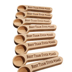 Set of wooden spoons with 'Best Team Ever #5442' engraving on a white background