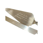 Silver cake server set with engraved text on a white background