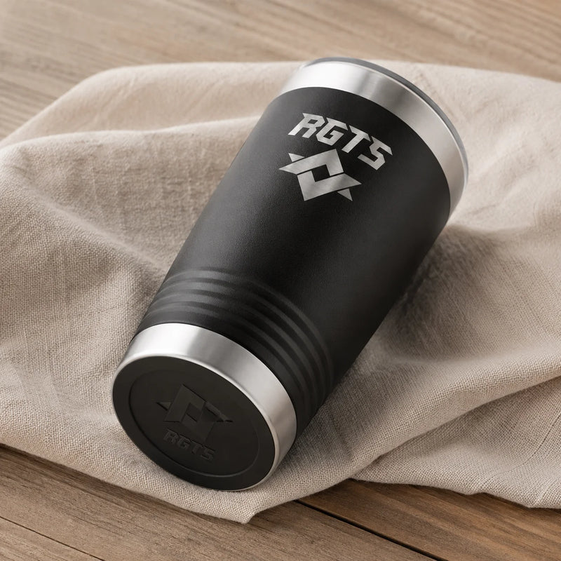 A black insulated tumbler with silver metal rims and a silver RGTS logo, resting on a beige linen cloth over a wooden surface.