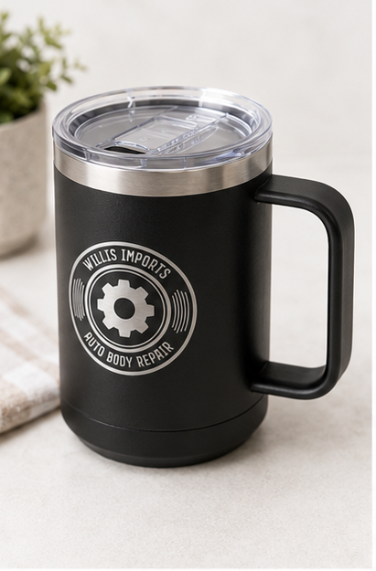 A collage showing a black handled insulated mug from multiple angles, with a clear lid and a circular 'WALLIS IMPORTS AUTO BODY REPAIR' gear logo printed on the side. The mug is shown on a light surface, on a wooden table with wrenches, open to reveal the stainless interior, and close-up to show the lid and logo detail.