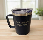 Black insulated mug with a clear lid on a wooden surface, customizable with a logo.
